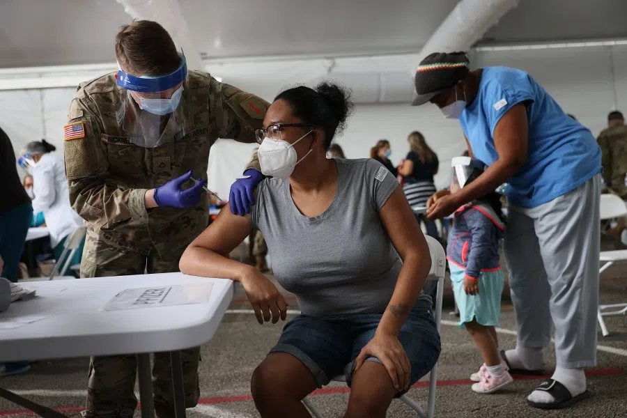 A woman receives the Covid-19 vaccine at the Miami Dade College North Campus on 9 March 2021 in North Miami, Florida. (Joe Raedle/AFP)