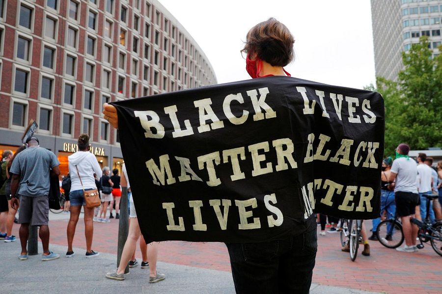 A demonstrator holds a Black Lives Matter banner during Action Against Police Brutality's march demanding a special prosecutor to reopen past cases of police brutality in Boston, Massachusetts, US, 9 September 2020. (Brian Snyder/Reuters)