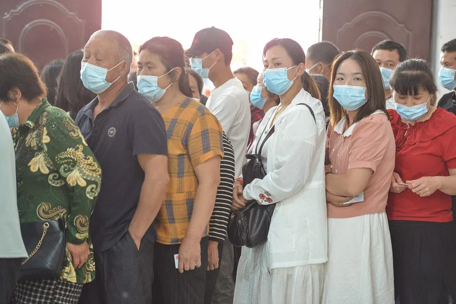 People queue to receive the Anhui Zhifei Longcom Covid-19 vaccine in Linquan county, Fuyang city, Anhui province, China, on 25 May 2021. (STR/AFP)