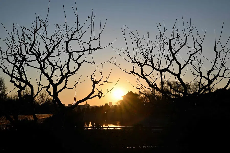 The sun rises over the Forbidden City in Beijing on 18 March 2025. (Adek Berry/AFP)