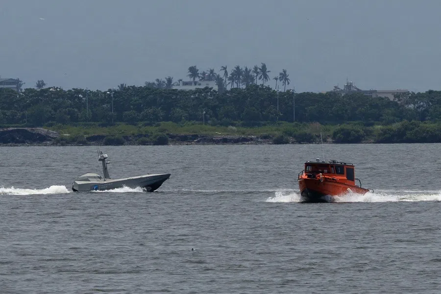 A Thunder Tiger SeaShark 600 unmanned surface vessel pursues an orange target boat during a maritime technology demonstration at Dapeng Bay in Pingtung on 29 July 2026.