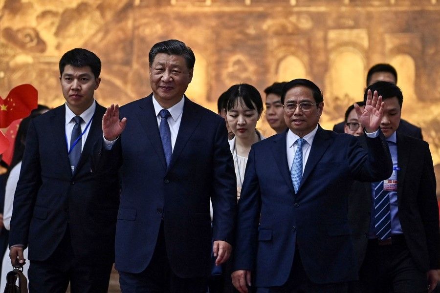 Vietnam's Prime Minister Pham Minh Chinh (centre right) bids farewell to China's President Xi Jinping (centre left) after their meeting at the Government Office in Hanoi on 13 December 2023. China and Vietnam pledged on 12 December to deepen ties during President Xi Jinping's first visit in six years. (Nhac Nguyen/AFP)