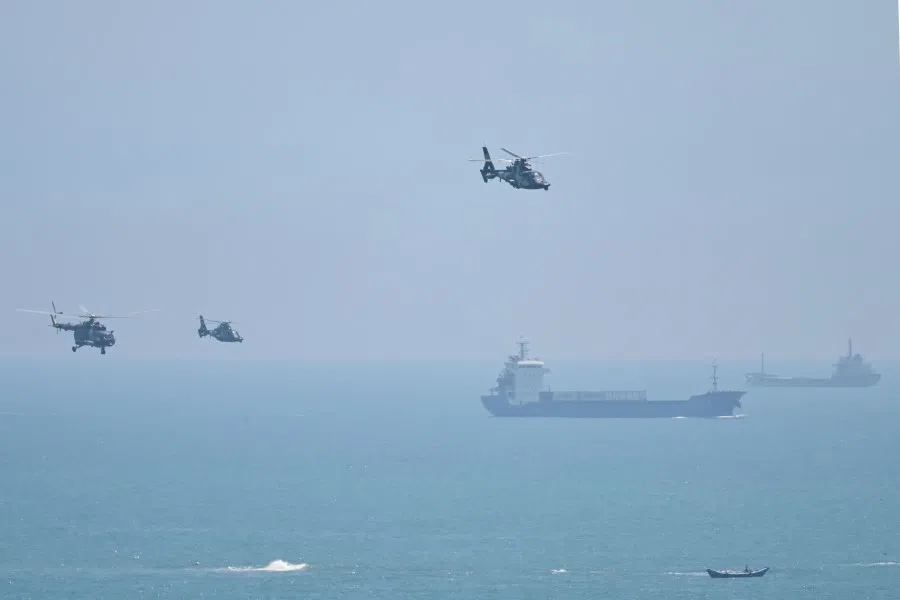 Chinese military helicopters fly past Pingtan island, one of mainland China's closest points from Taiwan, in Fujian province on 4 August 2022, ahead of massive military drills off Taiwan following US House Speaker Nancy Pelosi's visit to the self-ruled island. (Hector Retamal/AFP)