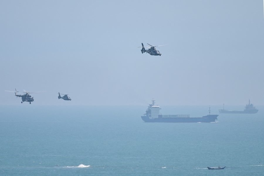 Chinese military helicopters fly past Pingtan island, one of mainland China's closest points from Taiwan, in Fujian province on 4 August 2022, ahead of massive military drills off Taiwan following US House Speaker Nancy Pelosi's visit to the self-ruled island. (Hector Retamal/AFP)