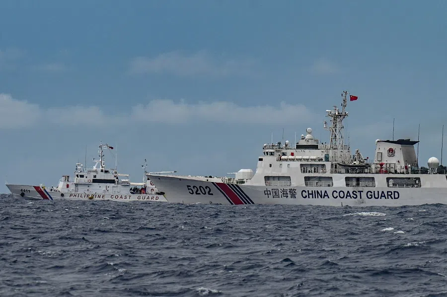 A China Coast Guard ship (right) is seen past the Philippine Coast Guard ship BRP Cape Engaño, as photographed from the BRP Cabra during a supply mission to Sabina Shoal in disputed waters of the South China Sea on 26 August 2024. (Jam Sta Rosa/AFP)