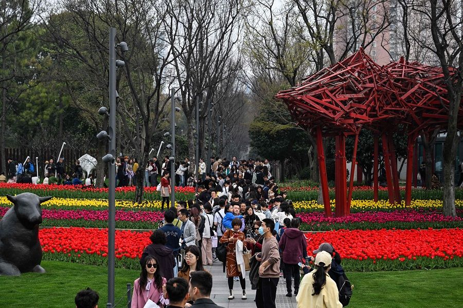 People visit the Jing'an sculpture park in the Jing'an district in Shanghai on 24 March 2024. (Hector Retamal/AFP)