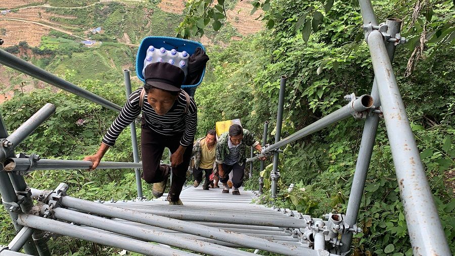 Villagers climbing a series of steel stairs and ladders to reach their homes in the village of Atulie'er in Liangshan Yi Autonomous Prefecture in Sichuan province, China. (SPH)