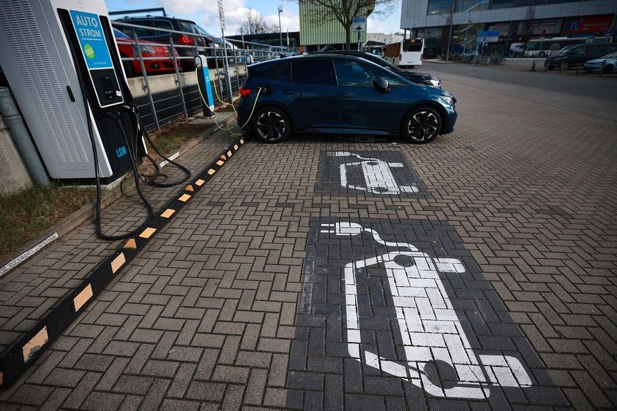 A CUPRA Born electric vehicle (EV) at a charging station in the parking lot of a train station in Wolfsburg, Germany, on 28 February 2023. (Krisztian Bocsi/Bloomberg)