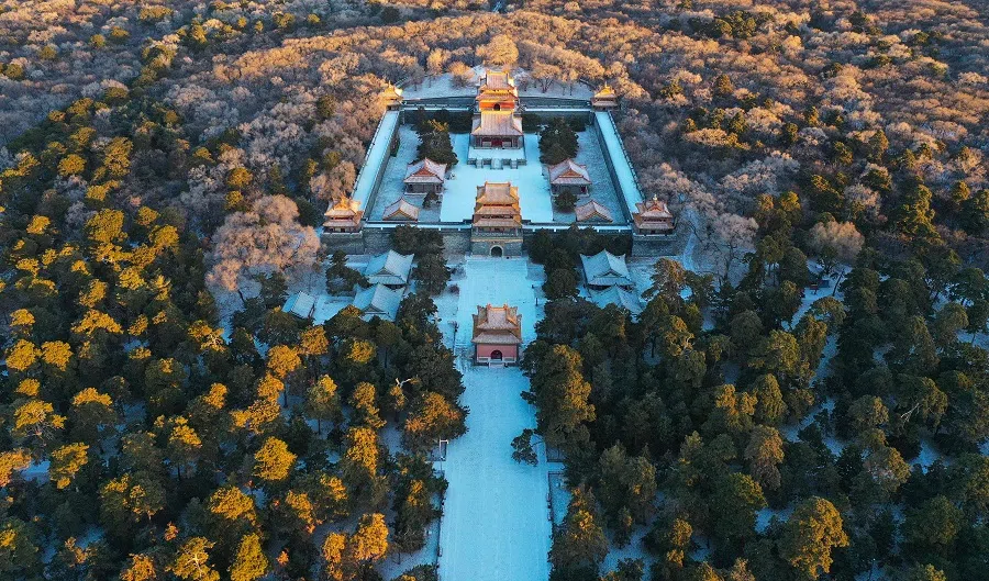 This aerial photo taken on 3 December 2022 shows an aerial view of Beiling Park after snowfall in Shenyang, Liaoning province, China. (AFP)
