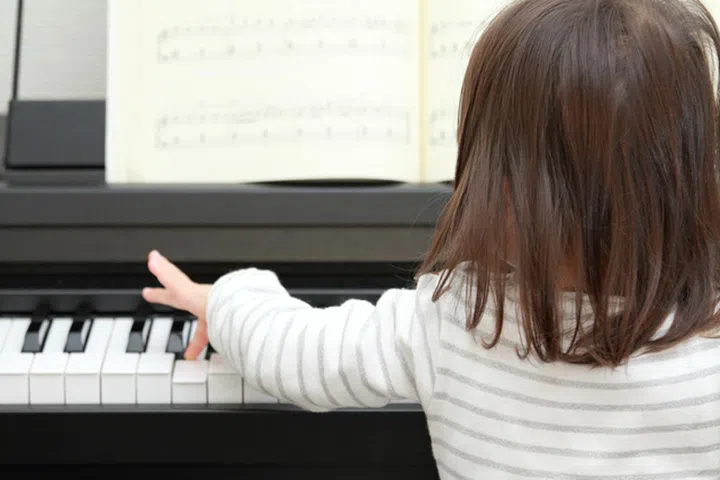 Japanese girl playing a piano (2 years old)
