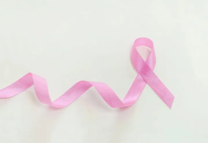 Breast cancer concept, pink ribbon on white background