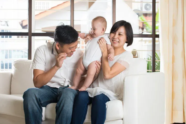 asian parent with smelly baby diaper

