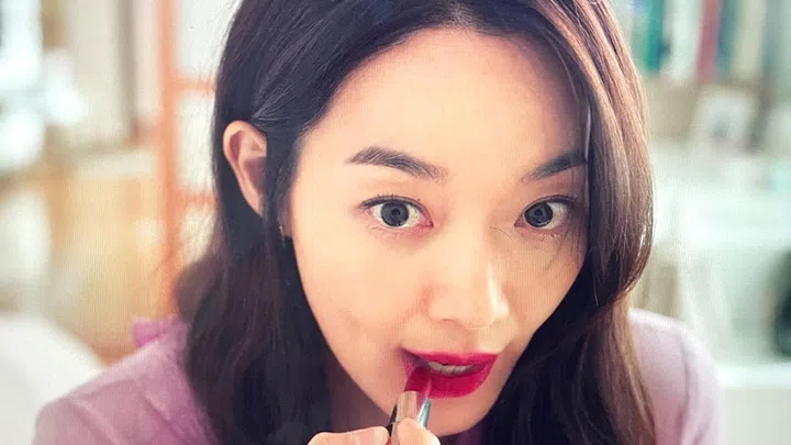 Lead character in Netflix's K-Drama, Hometown Cha Cha Cha, Yoon Hye Jin applying a red lipstick from Givenchy Beauty.