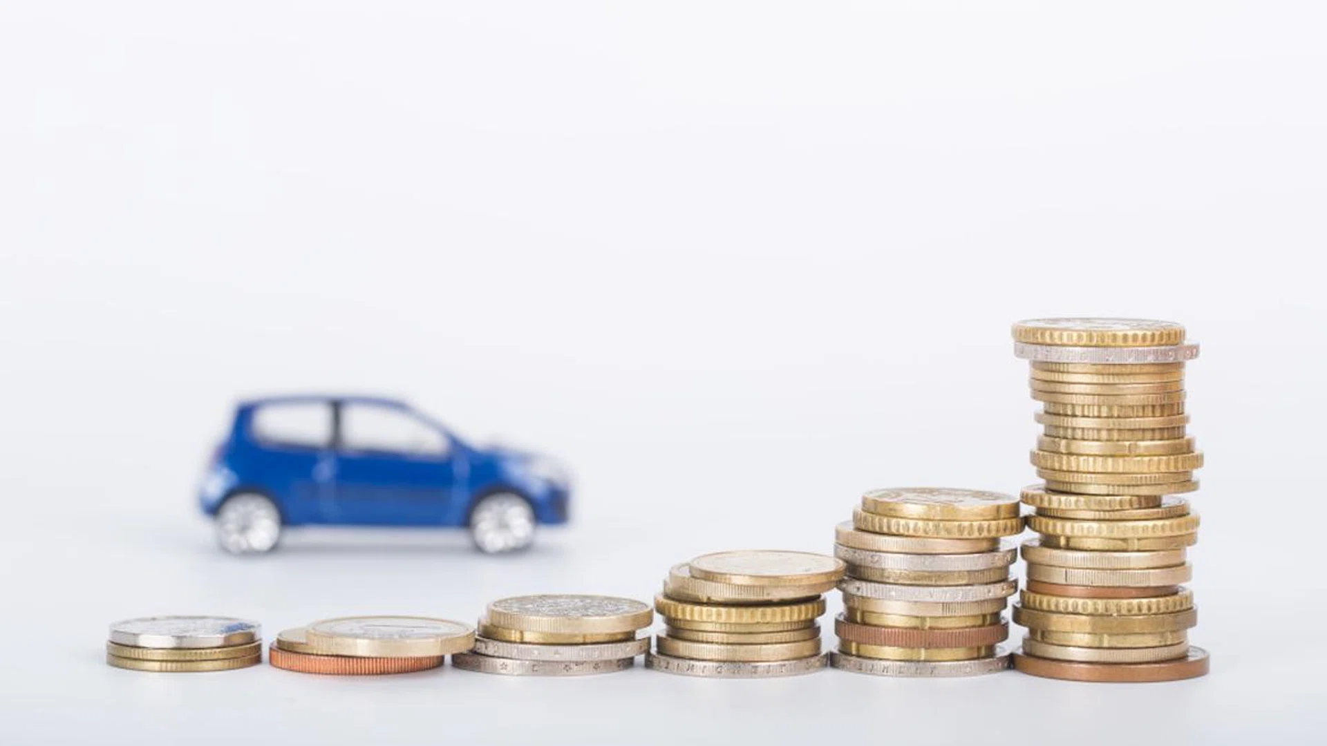 Car finance money stack with white background.
