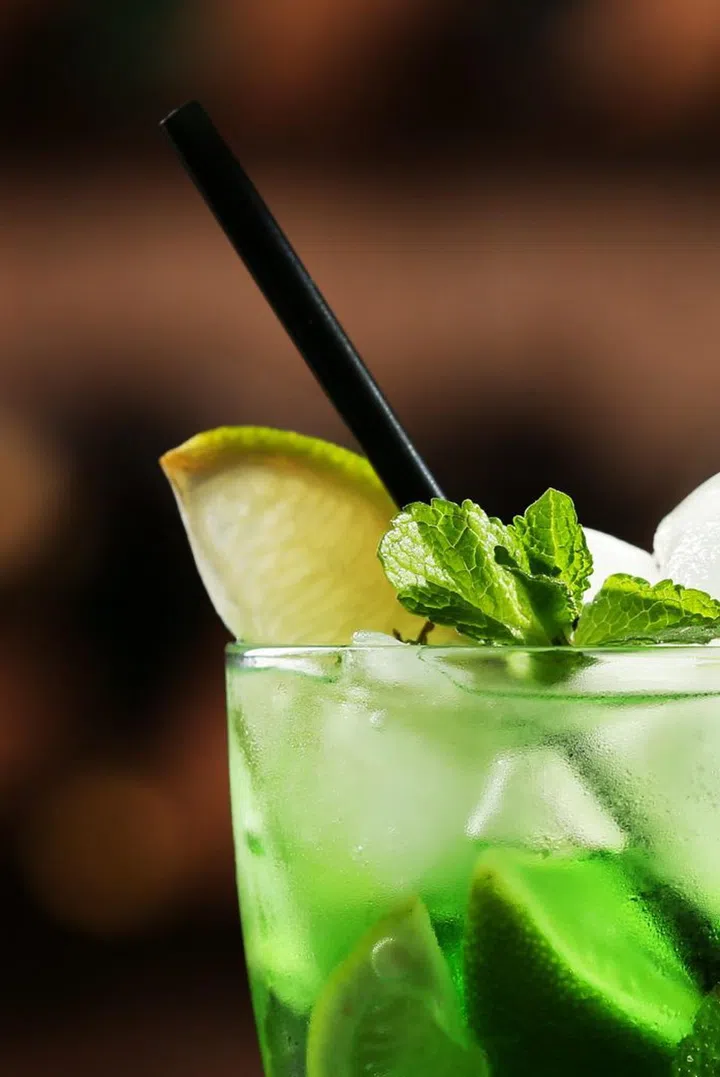 Glasses of cocktails on bar background