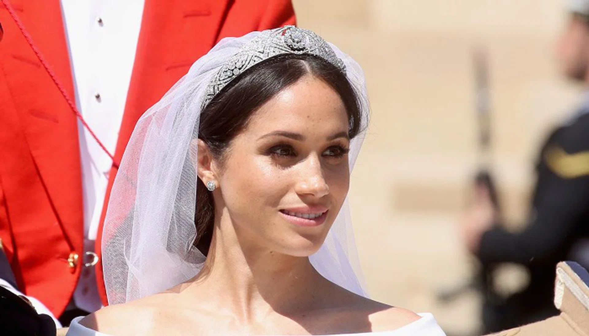 Prince Harry and Meghan Markle ride in an open-topped carriage through Windsor Castle after their wedding in St George's Chapel.