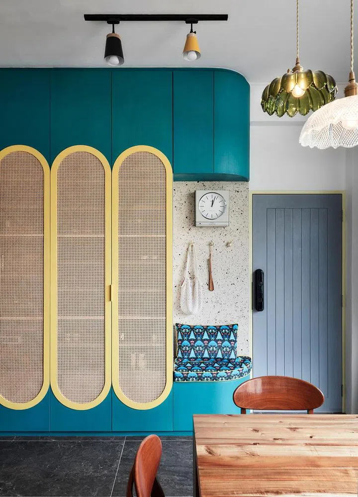 Closeup of the bright colours, shapes, and patterns in the entryway shoe cabinet in this 2-bedroom walk-up apartment along East Coast Road.