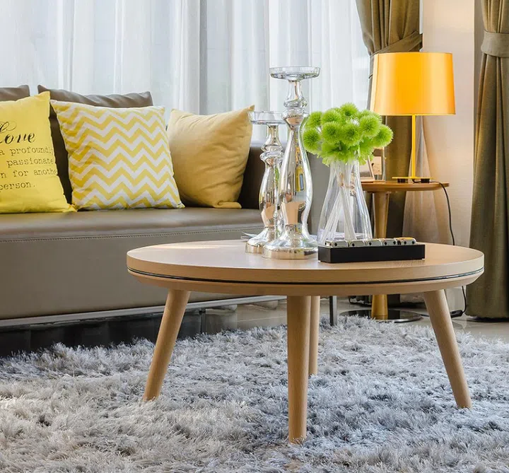 wooden round table on carpet in modern living room