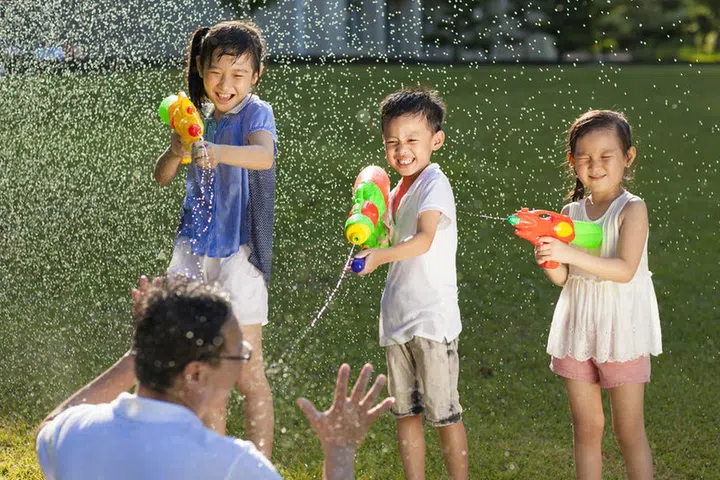 29966118 - little guys using water guns to spray their father