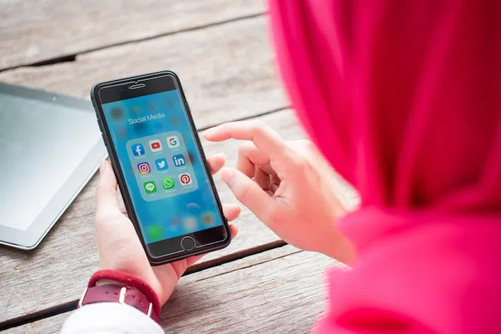 BANGKOK, THAILAND- 10th August 2019 : Hands of Islamic woman use Iphone 7 plus with social media application of facebook, youtube, google search, instagram, twitter, linked in, line whatsapp, and pinterest