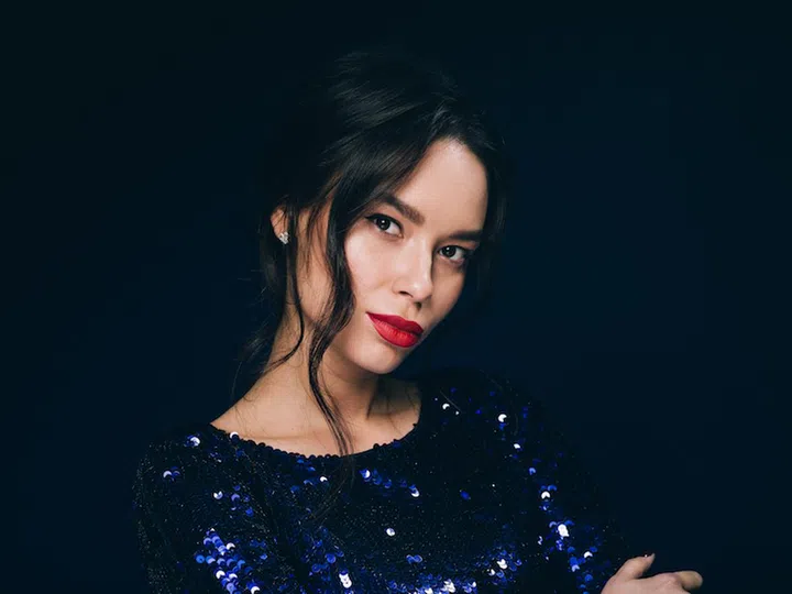 Woman in sequin dress night club concept red lips asian beauty. Studio shot.