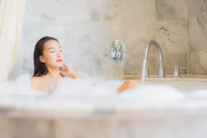 Portrait beautiful young asian woman relax take a bath in bathtub in bathroom interior