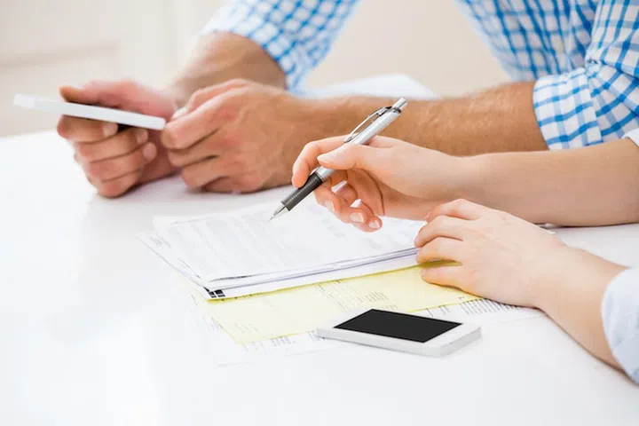 Couple calculating bills at home