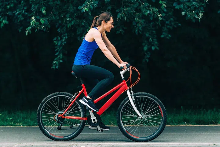 Woman Riding Bike in Park
