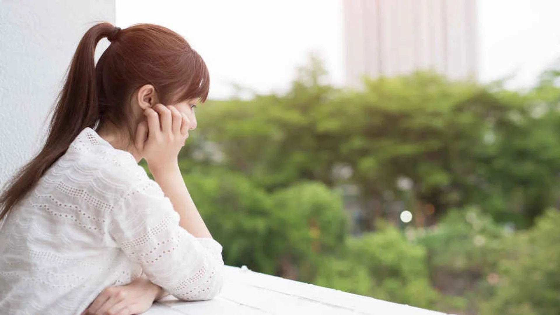 woman feel depression and next to the balcony