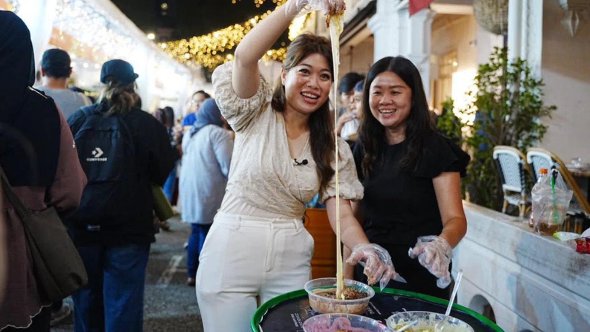 Berita Harian journalist Dahlia Zulkifli (left) and STFood Online Editor Eunice Quek ate their way through this year's Kampong Gelam Ramadan Bazaar. Credit: Berita Harian