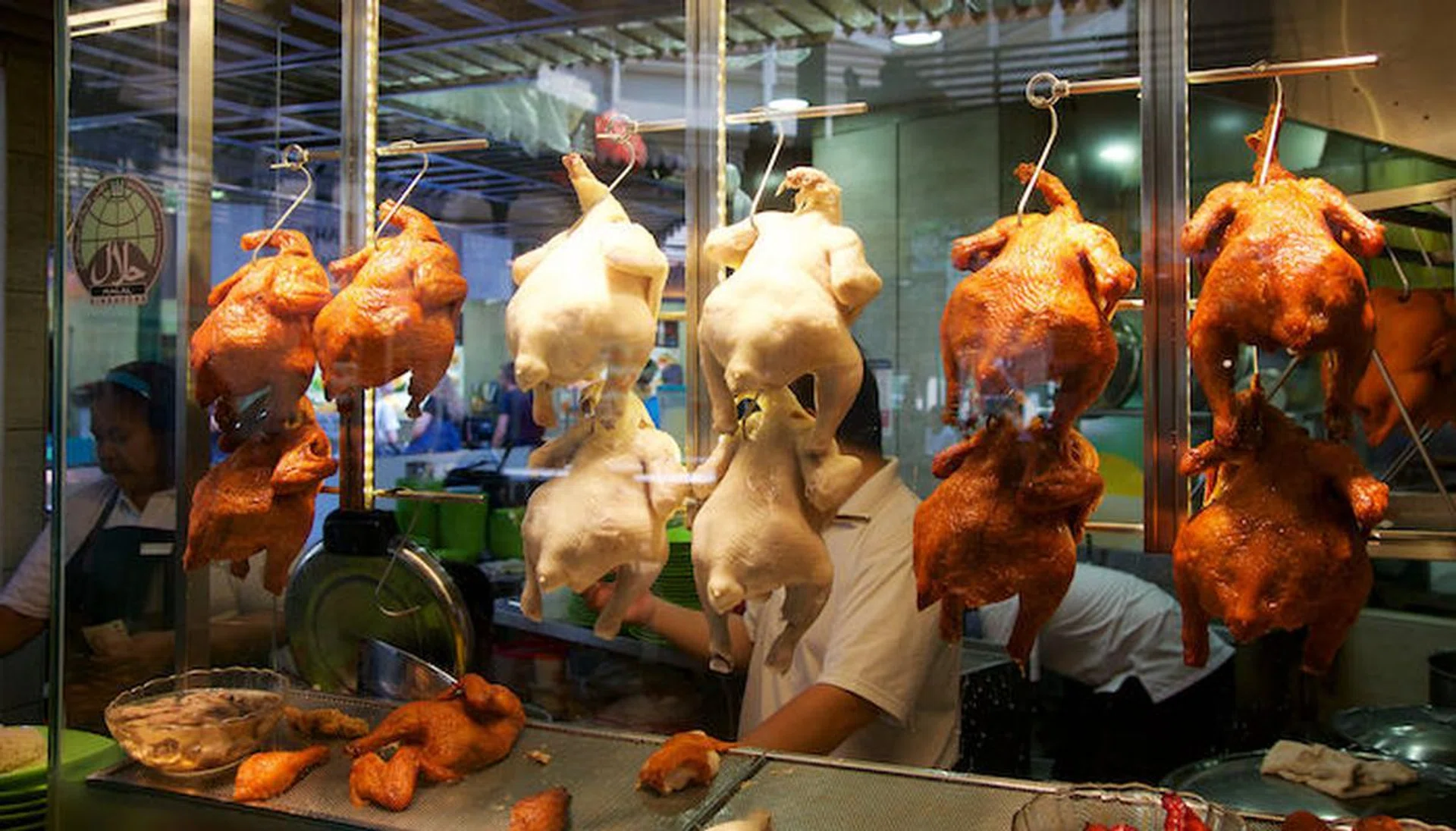 81985241 - singapore - july 23rd, 2016: duck grilled or roasted hanging in cupboard-glass at lau pa sat festival market