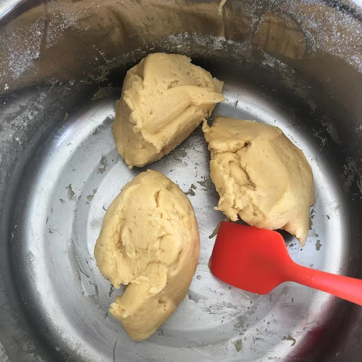 04. Add flour and mix ingredients well to make a stiff dough. Cut dough into 4 sections, and set aside 3 sections. 