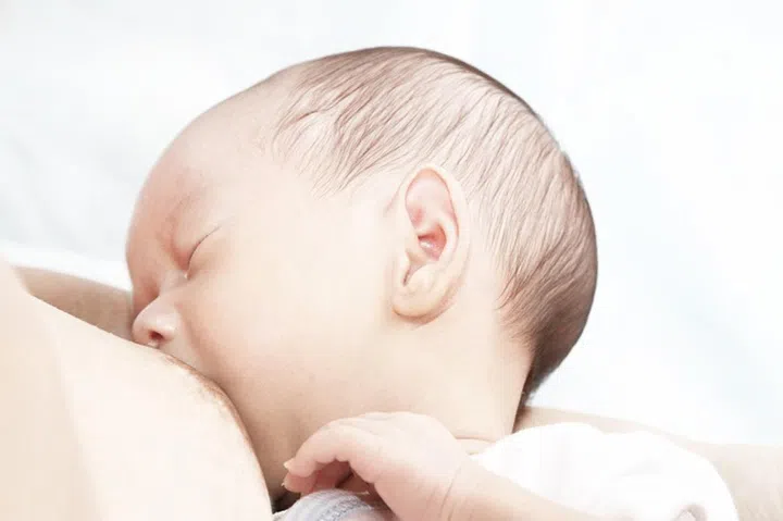 A baby boy being breastfed