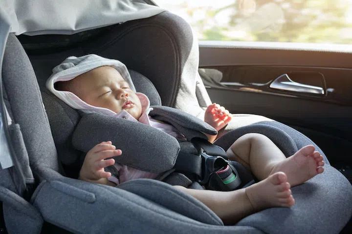 66581236 - close up asian cute newborn baby sleeping in modern car seat. child new born traveling safety on the road. safe way to travel fastened seat belts in a vehicle with young kids. trip with an infant.