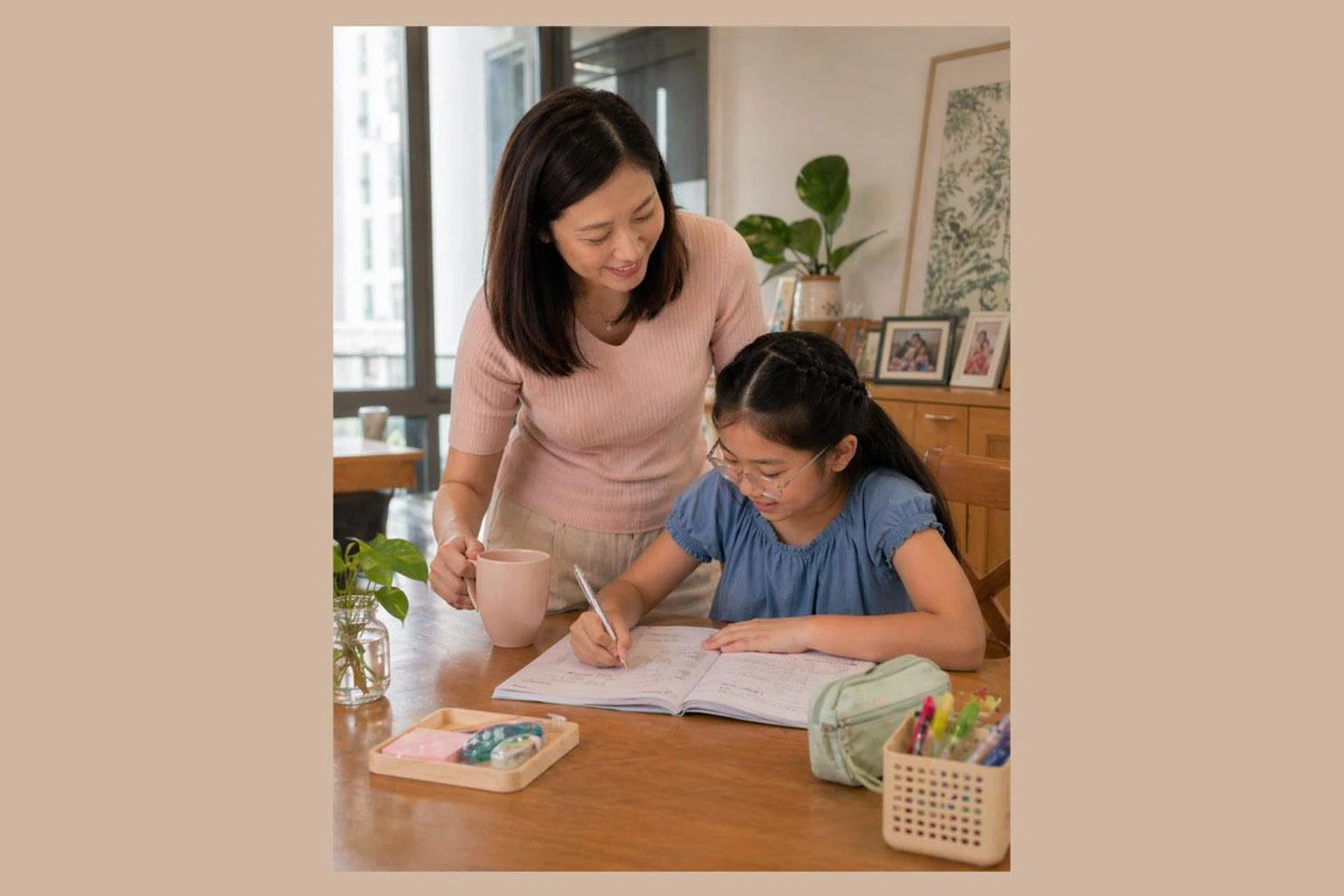 Asian mum helping daughter study for the PSLE exam