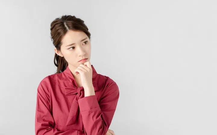 Thinking asian woman.