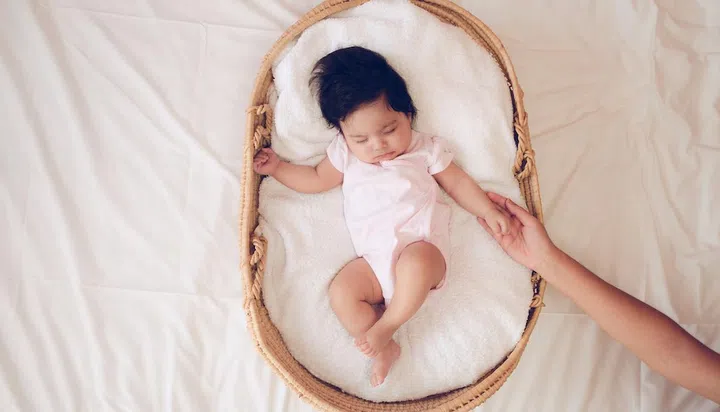 Baby sleeping in a basket