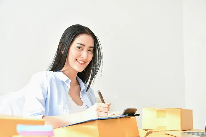 Sme business concept. Young people are packing their packages.Delivery business  Small and Medium Enterprise (SMEs). Young woman is working in the house.Young Owner Start up for Business Online.