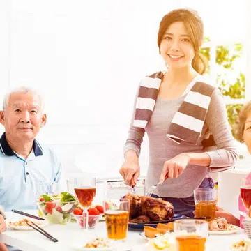 An Asian family having a meal in the day for Father's Day