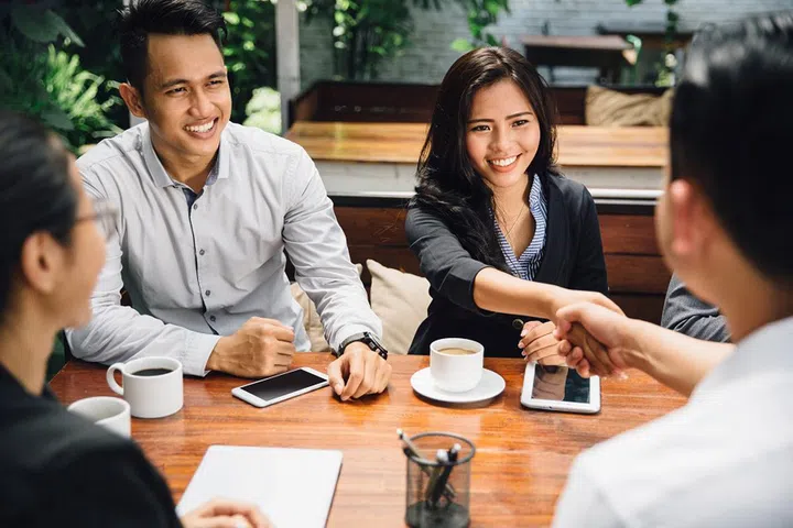 portrait of Business people shaking hands, finishing up a meeting