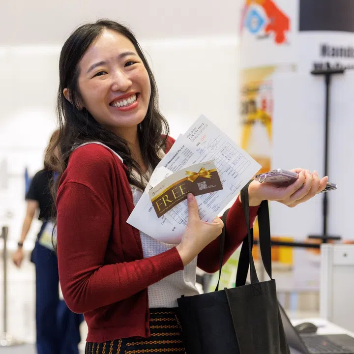 happy shopper with goodie bag at the health bazaar 2024, suntec city