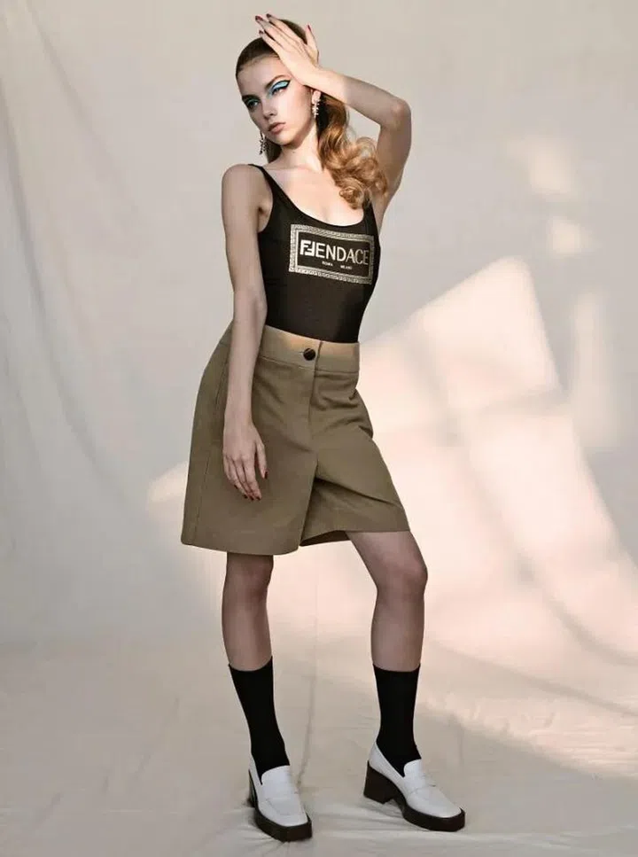 Fendace swimsuit, Fendi. Cotton bermudas, Salvatore Ferragamo. Calfskin loafers, Tod’s. Embellished earrings, Givenchy. Socks, stylist’s own
