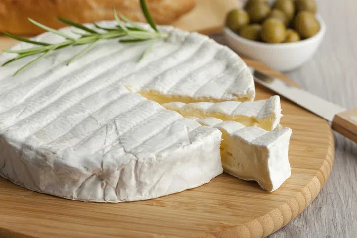 Fresh Brie cheese and a slice