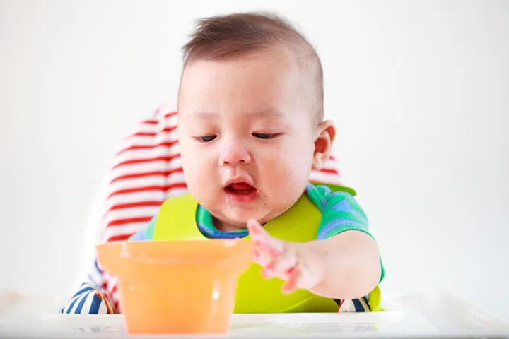 baby child eating in chair