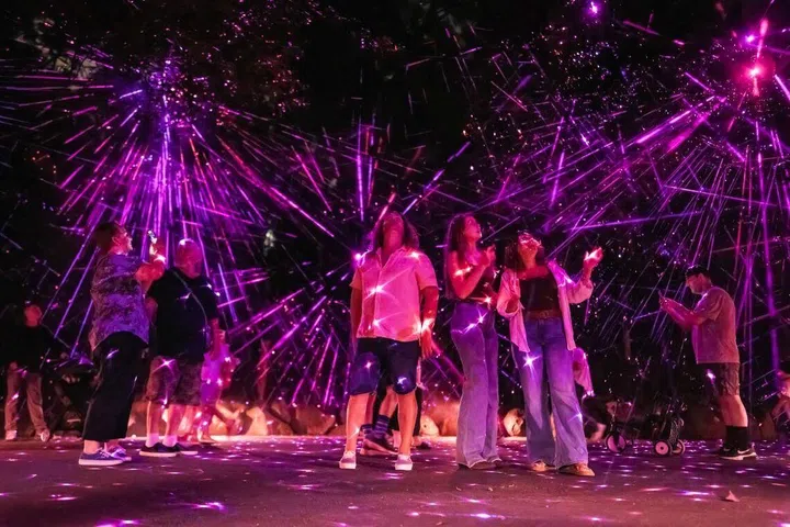 Guests enjoying an immersive, multi-sensory trail of light, sound and storytelling at Astra Lumina, Queensland, Australia