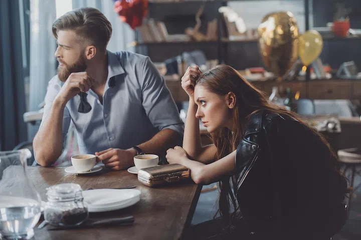 man and woman drinking coffee after party at home