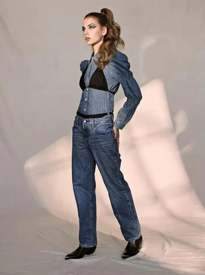 Denim shirt with puffy sleeves and straight-cut jeans, Levi’s. Bikini top and bottom, Loewe. Calfskin boots, Celine