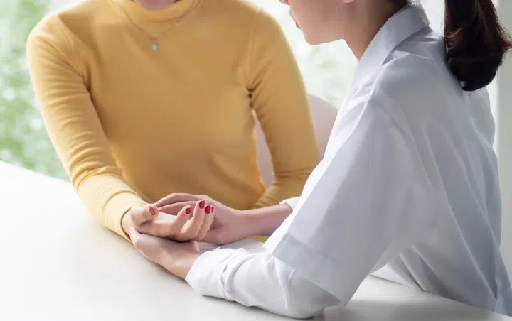 Traditional Chinese Medicine, TCM, alternative medicine woman doctor measuring pulse, testing acupressure point of patient; concept of asian alternative medicine, ancient Chinese medicine doctor