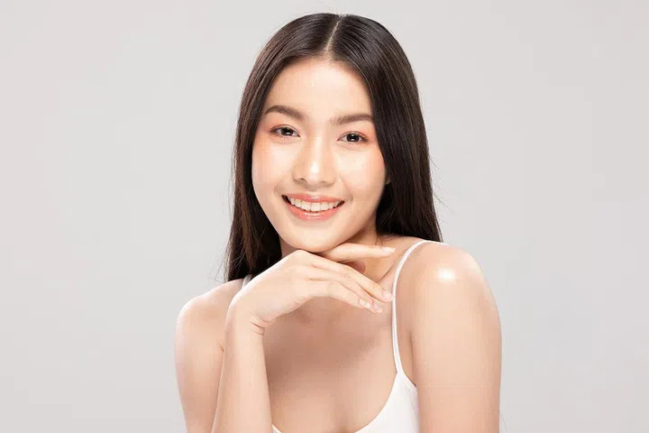 Beautiful Asian woman touching chin smile with clean and fresh skin Happiness and cheerful with positive emotional,isolated on white background,Beauty and Cosmetics Concept