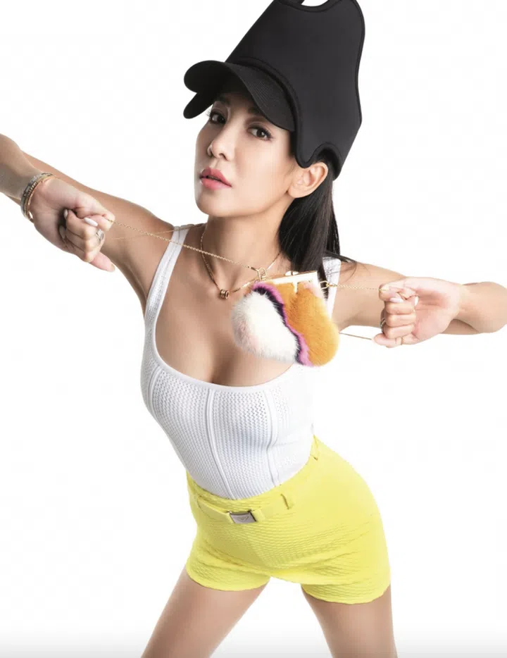 Ribbed cotton bodysuit, Bottega Veneta. Skort with attached belt, Prada. Felt cap, Burberry. Mini fur purse with chain sling, Fendi. B.zero1 Rock rose gold pendant necklace with black ceramic, B.zero1 Rock 18K rose gold bracelet with black ceramic, B.zero1 white gold bangle, B.zero1 5-band 20th Anniversary white gold ring, and B.zero1 5-band 20th Anniversary white gold ring with pave diamonds, Bvlgari